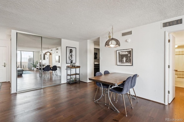 1020 15th St Unit 28G, Denver, CO 80202 - dining room featuring dark wood finished floors and a textured ceiling