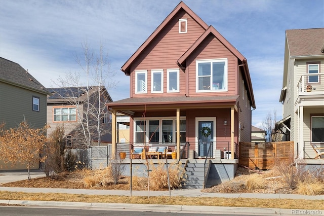 view of front facade with covered porch and fence