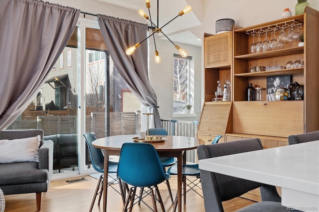 dining room with light wood finished floors and visible vents