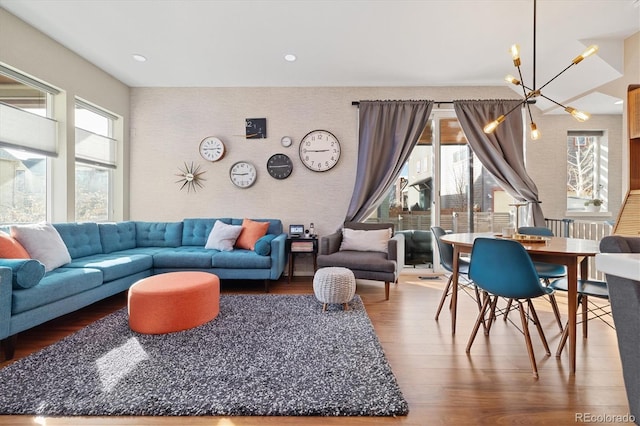 living room featuring an inviting chandelier, wallpapered walls, wood finished floors, and recessed lighting