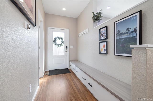 mudroom with wood finished floors and a textured wall