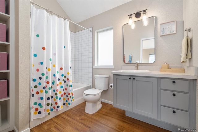 full bathroom featuring toilet, shower / bath combo with shower curtain, vaulted ceiling, vanity, and wood finished floors