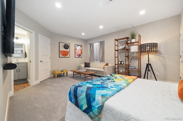 carpeted bedroom with baseboards, connected bathroom, and recessed lighting