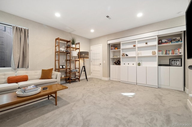 sitting room featuring recessed lighting, visible vents, baseboards, and light colored carpet