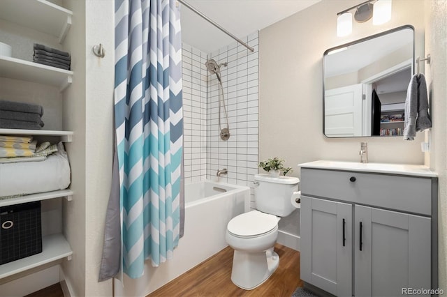 full bathroom with toilet, wood finished floors, vanity, baseboards, and shower / tub combo with curtain