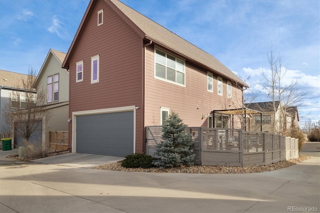 view of side of home with a garage and driveway