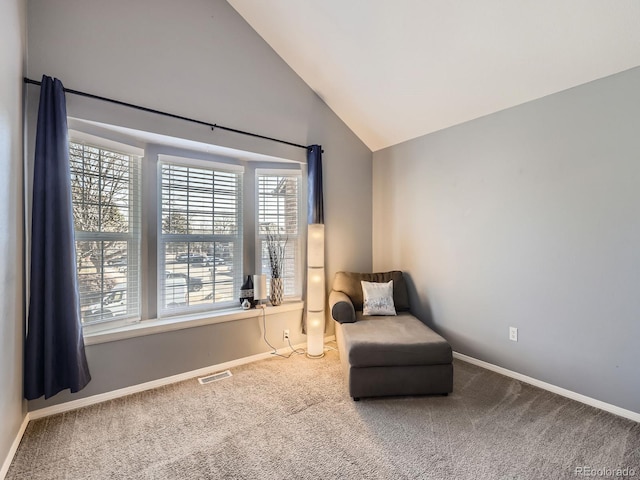 living area with lofted ceiling and carpet flooring