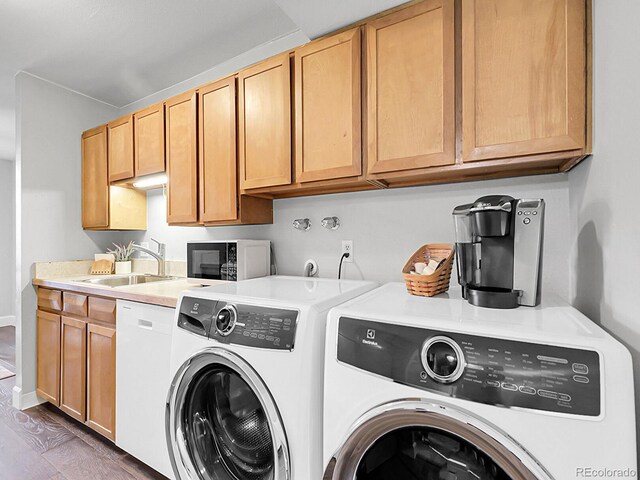 7318 S Xenia Cir Unit B, Centennial, CO 80112 - washroom featuring separate washer and dryer, cabinet space, and wood finished floors
