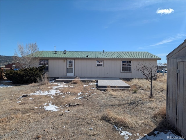 rear view of property with solar panels