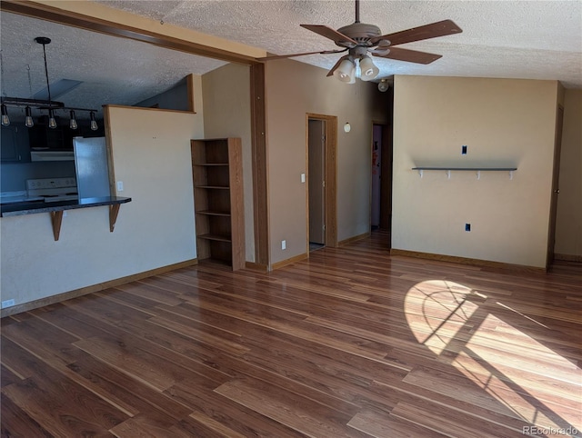 unfurnished living room featuring lofted ceiling, hardwood / wood-style floors, a textured ceiling, and ceiling fan