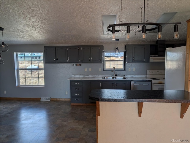 kitchen featuring sink, refrigerator, white range with electric cooktop, a kitchen bar, and stainless steel dishwasher