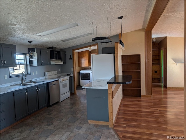 kitchen with sink, hanging light fixtures, dark hardwood / wood-style flooring, white appliances, and washer / clothes dryer