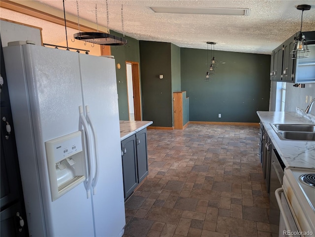 kitchen featuring sink, range with electric cooktop, a textured ceiling, pendant lighting, and white refrigerator with ice dispenser