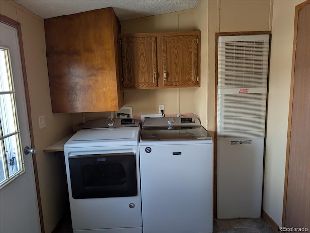 washroom with cabinets and washing machine and dryer