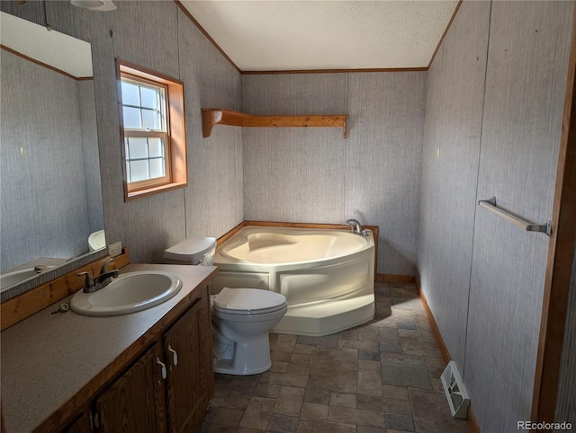 bathroom featuring a washtub, vanity, crown molding, and toilet