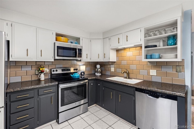 32 Powder Horn Pl, Longmont, CO 80504 - kitchen with stainless steel appliances, open shelves, white cabinets, light tile patterned flooring, and tasteful backsplash
