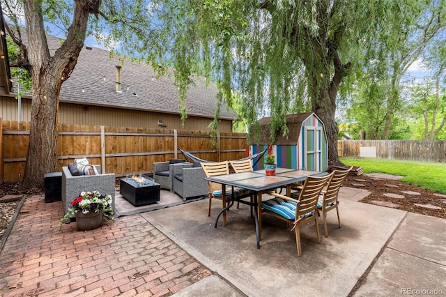 32 Powder Horn Pl, Longmont, CO 80504 - fenced backyard featuring an outdoor fire pit, outdoor dining area, a patio, and a storage unit