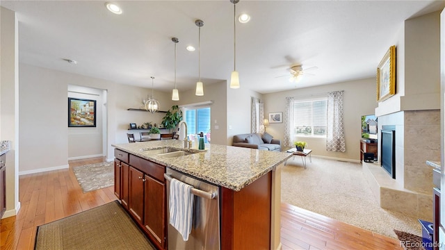 17114 Elati St, Broomfield, CO 80023 - kitchen with dishwasher, open floor plan, plenty of natural light, a fireplace with raised hearth, and recessed lighting