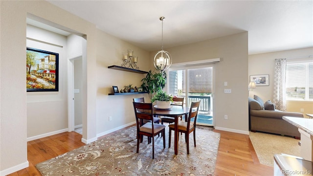 17114 Elati St, Broomfield, CO 80023 - dining area featuring wood finished floors, a chandelier, and healthy amount of natural light