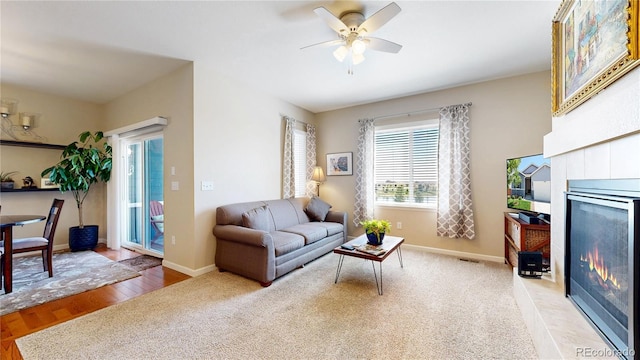 17114 Elati St, Broomfield, CO 80023 - living room with a tile fireplace, ceiling fan, and light wood finished floors