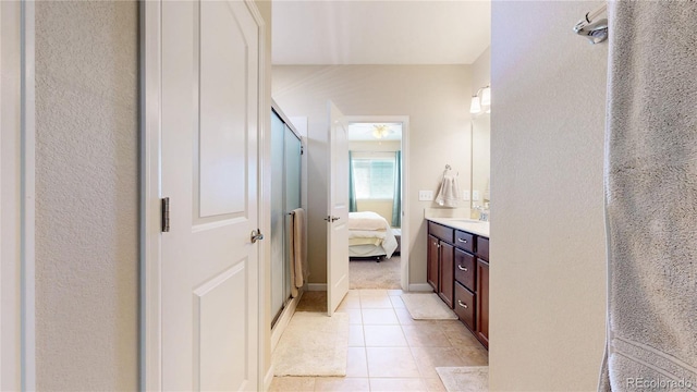 17114 Elati St, Broomfield, CO 80023 - ensuite bathroom featuring vanity, tile patterned flooring, and a shower with shower door