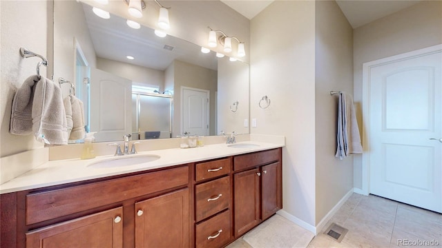 17114 Elati St, Broomfield, CO 80023 - bathroom with double vanity, a shower stall, and tile patterned flooring