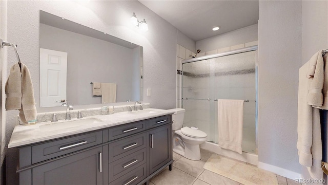 17114 Elati St, Broomfield, CO 80023 - full bathroom with a textured wall, double vanity, a shower stall, and tile patterned flooring