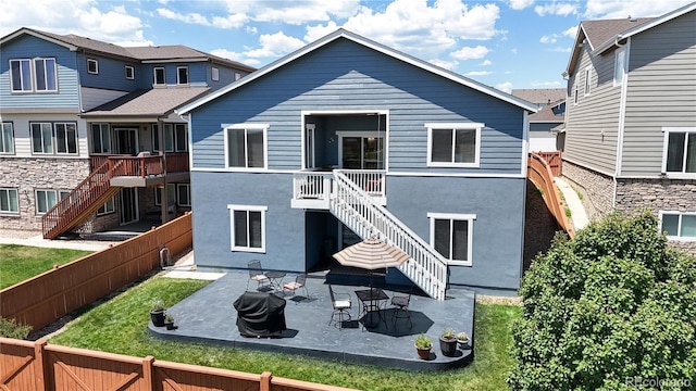 17114 Elati St, Broomfield, CO 80023 - back of house featuring stairway, a fenced backyard, a patio, and stucco siding