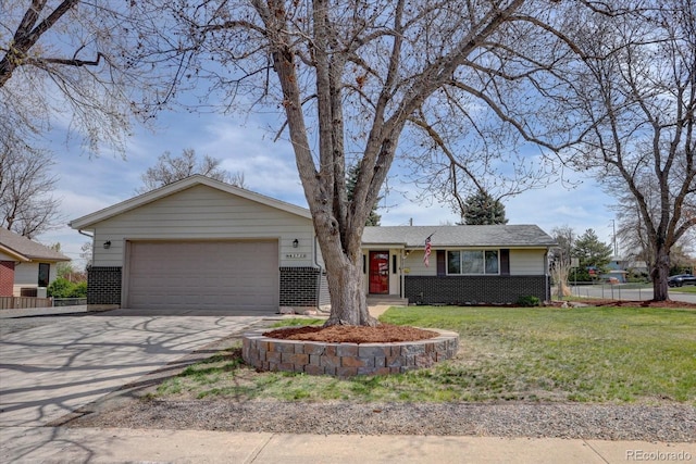 ranch-style house with fence, an attached garage, brick siding, a front yard, and concrete driveway