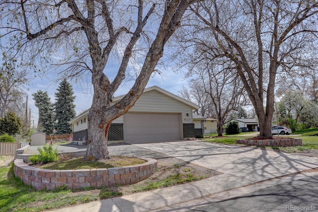 view of property exterior with an attached garage, driveway, and brick siding