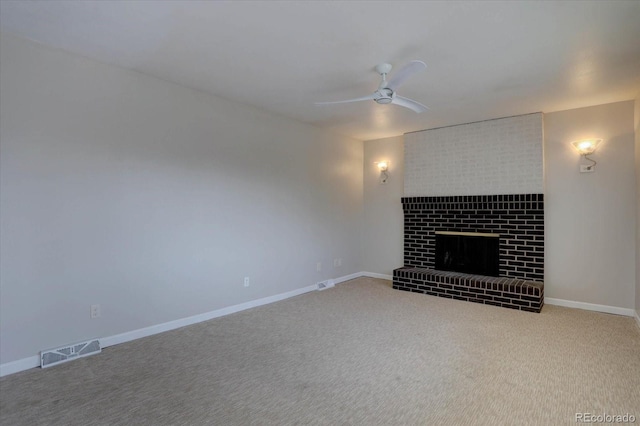 unfurnished living room featuring a ceiling fan, visible vents, a brick fireplace, baseboards, and carpet flooring