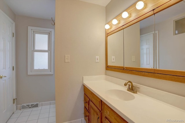 bathroom with baseboards, visible vents, tile patterned floors, and vanity