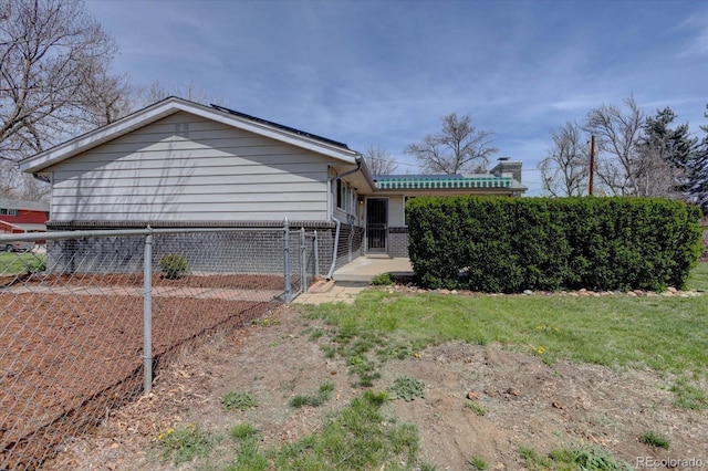rear view of property featuring fence and a chimney