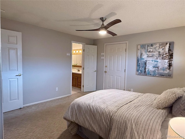 6272 S Garfield Dr, Centennial, CO 80121 - bedroom with light carpet, a textured ceiling, baseboards, connected bathroom, and a sink