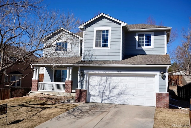 view of front facade featuring a garage, driveway, fence, and brick siding