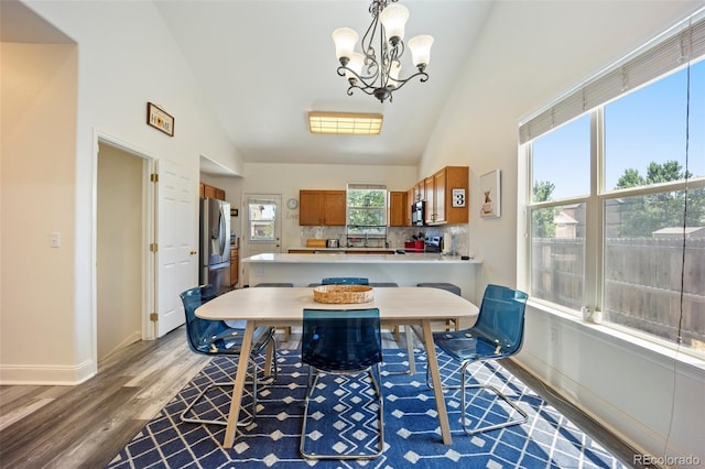 1884 Asoka St, Strasburg, CO 80136 - dining space with light wood-type flooring, a chandelier, and high vaulted ceiling
