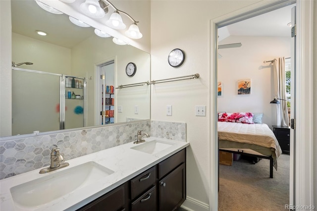 1884 Asoka St, Strasburg, CO 80136 - full bathroom with connected bathroom, double vanity, a shower stall, and backsplash
