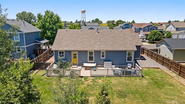 1884 Asoka St, Strasburg, CO 80136 - back of property with a fenced backyard, a residential view, roof with shingles, a patio area, and an outdoor hangout area