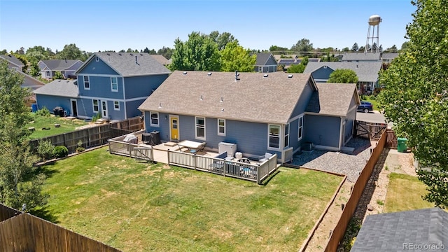 1884 Asoka St, Strasburg, CO 80136 - rear view of property with a fenced backyard, a residential view, roof with shingles, and an outdoor hangout area