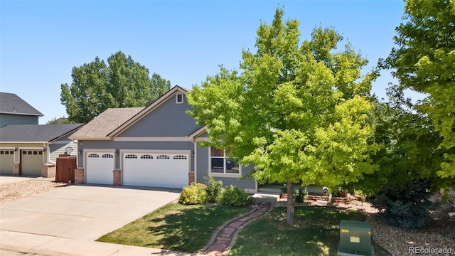 1884 Asoka St, Strasburg, CO 80136 - view of front of house with a garage, driveway, brick siding, and a front yard