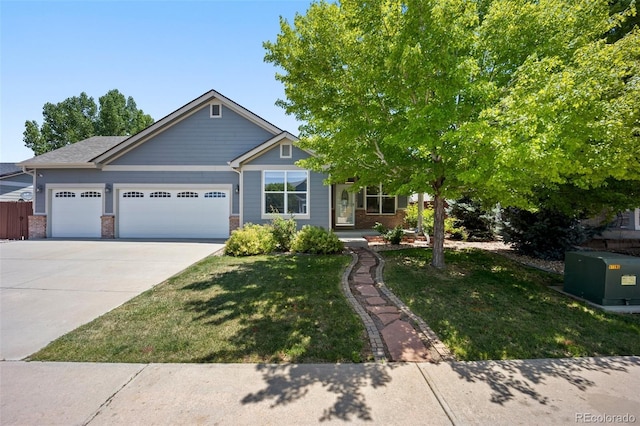 1884 Asoka St, Strasburg, CO 80136 - view of front facade with an attached garage, driveway, a front lawn, and brick siding