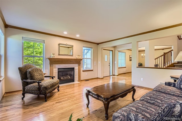 7855 Arundel Ln, Lone Tree, CO 80124 - living room featuring ornamental molding, stairs, a fireplace, light wood-style floors, and recessed lighting