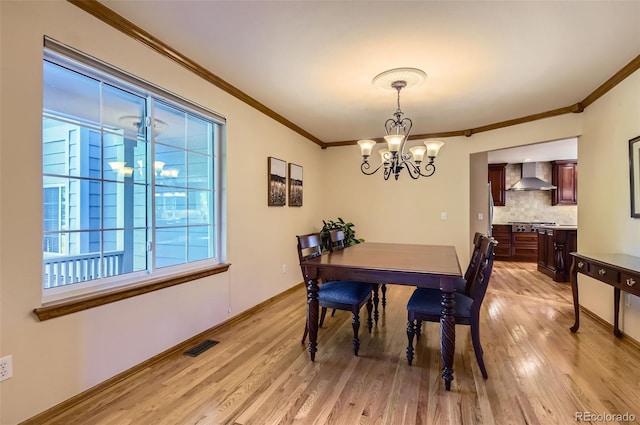 7855 Arundel Ln, Lone Tree, CO 80124 - dining area featuring crown molding, a chandelier, and light wood-type flooring