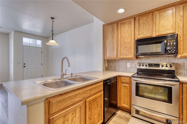 kitchen with pendant lighting, backsplash, black appliances, sink, and kitchen peninsula