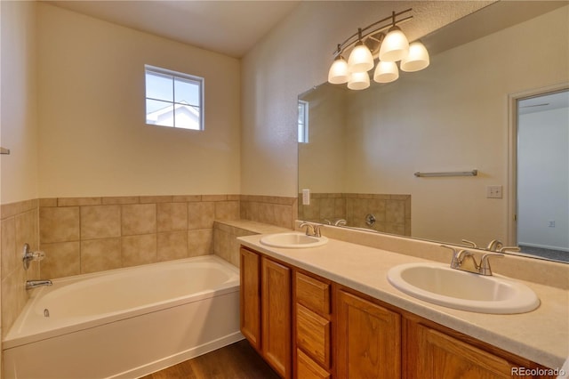 bathroom with a bathing tub, vanity, and hardwood / wood-style flooring