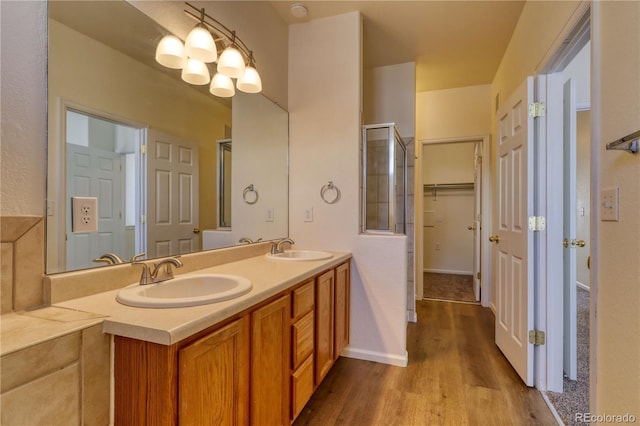 bathroom featuring vanity, hardwood / wood-style flooring, and an inviting chandelier