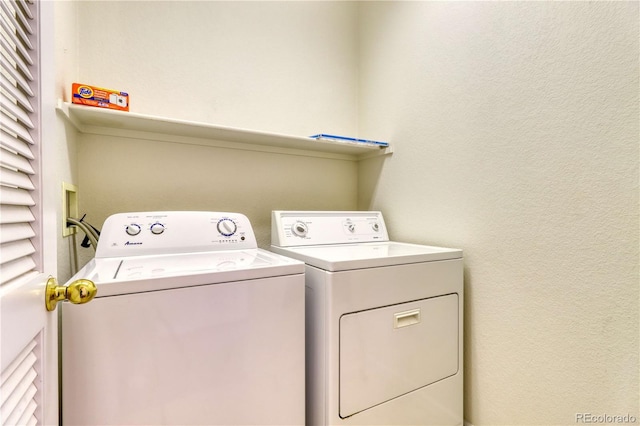 laundry room featuring washing machine and clothes dryer