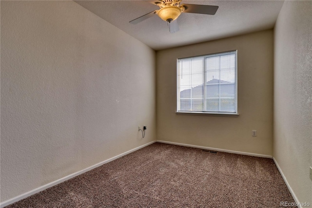 carpeted empty room featuring ceiling fan