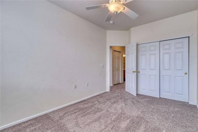 unfurnished bedroom featuring ceiling fan, light colored carpet, and a closet