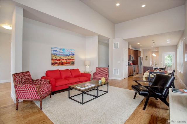 living room featuring light hardwood / wood-style flooring and sink